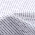 A close-up of white fabric with thin black vertical stripes and gentle folds—perfect for the FAHIZO Mens Dress Shirt Regular Fit Casual Long Sleeve Stripe Stretch Solid, combining style and comfort.